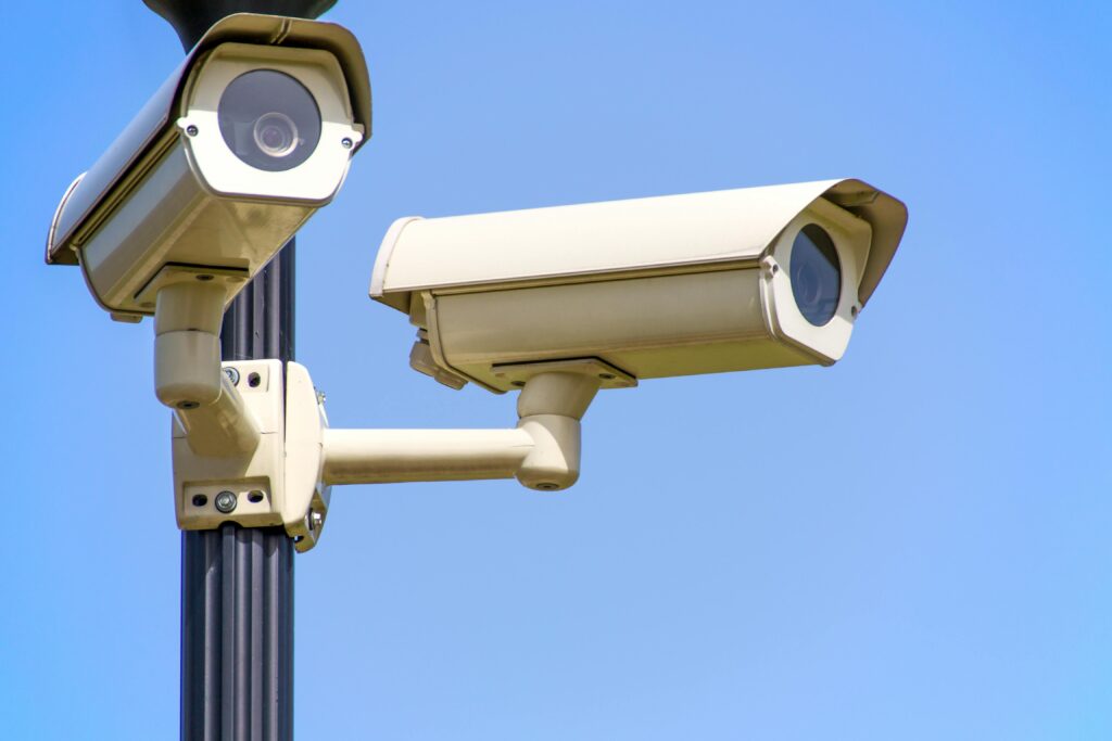 pexels photo 96612 96612 Outdoor security cameras mounted on a pole against a clear blue sky, ensuring vigilant surveillance.